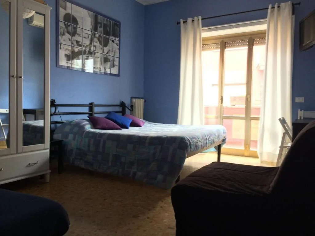 Quadruple Room with Balcony — Arches Inn