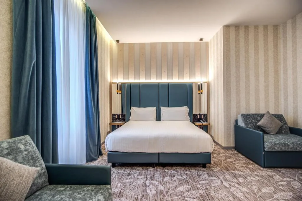 Deluxe Quadruple Room — CC Palace Hotel
