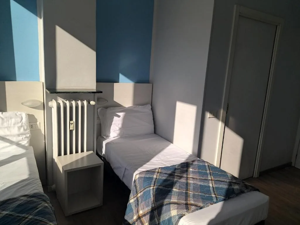 Basic Triple Room with Shared Bathroom — Hotel Kennedy