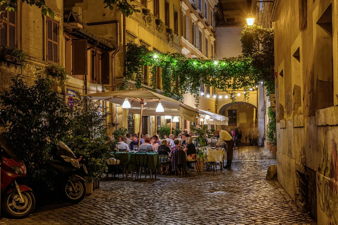 I vicoli di Trastevere a Roma, con l'edera e i sanpietrini, quartiere dall'atmosfera serale