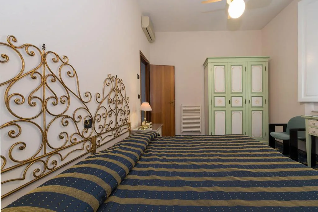 Quadruple Room — Hotel Corallo